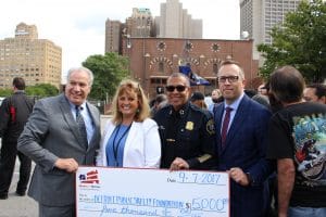 Homes for Heroes Specialist, Jamie Nummer, presents the Detroit Public Safety Foundation with a grant on behalf of the Homes for Heroes Foundation