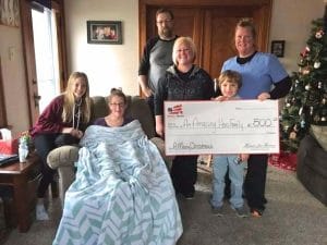 Homes for Heroes Specialist, Erica Schultes presents Iowa teacher with a $500 Chirstmas Miracle on behalf of Homes for Heroes.