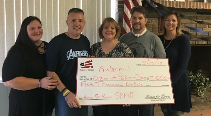 Homes for Heroes Specialist, Janet Saunier presents $5000 grant to the Fraternal Order of Police Jacksonville on behalf of the Homes for Heroes Foundation