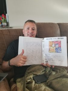 Police officer reading thank you letter from a student
