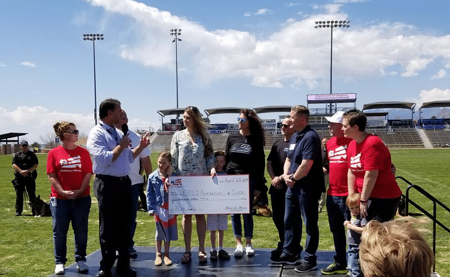 Rachel Flick is presented with a $5,000 grant from the Homes for Heroes Foundation