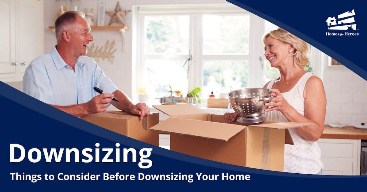 boomer couple in kitchen packing boxes in preparation for downsizing their home