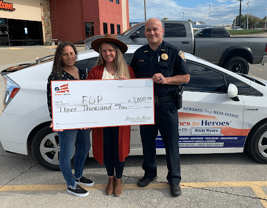 Homes for Heroes real estate affiliate Nikki Moore presents a check to the Tennessee Fraternal Order of Police for $3,000 on behalf of the Homes for Heroes Foundation