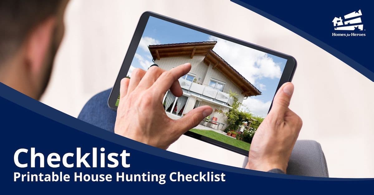 man on tablet looking at house after using Homes for Heroes Printable House Hunting checklist