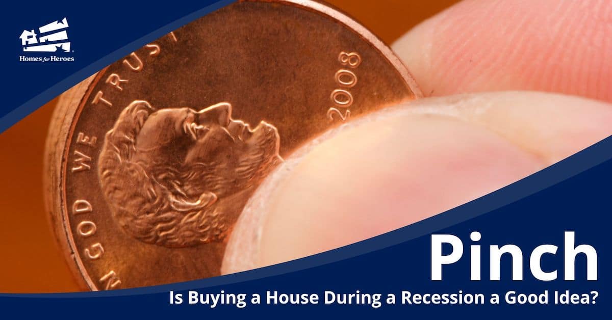 copper penny year 2008 close up pinched between finger thumb debating if buying a home during a recession is a good idea Homes for Heroes