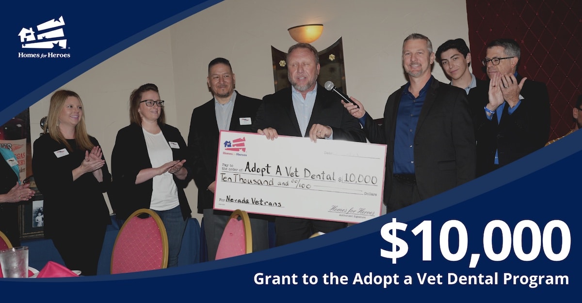 adopt a vet dental program receives 10000 homes for heroes foundation grant agent holding big check men women applaud at event