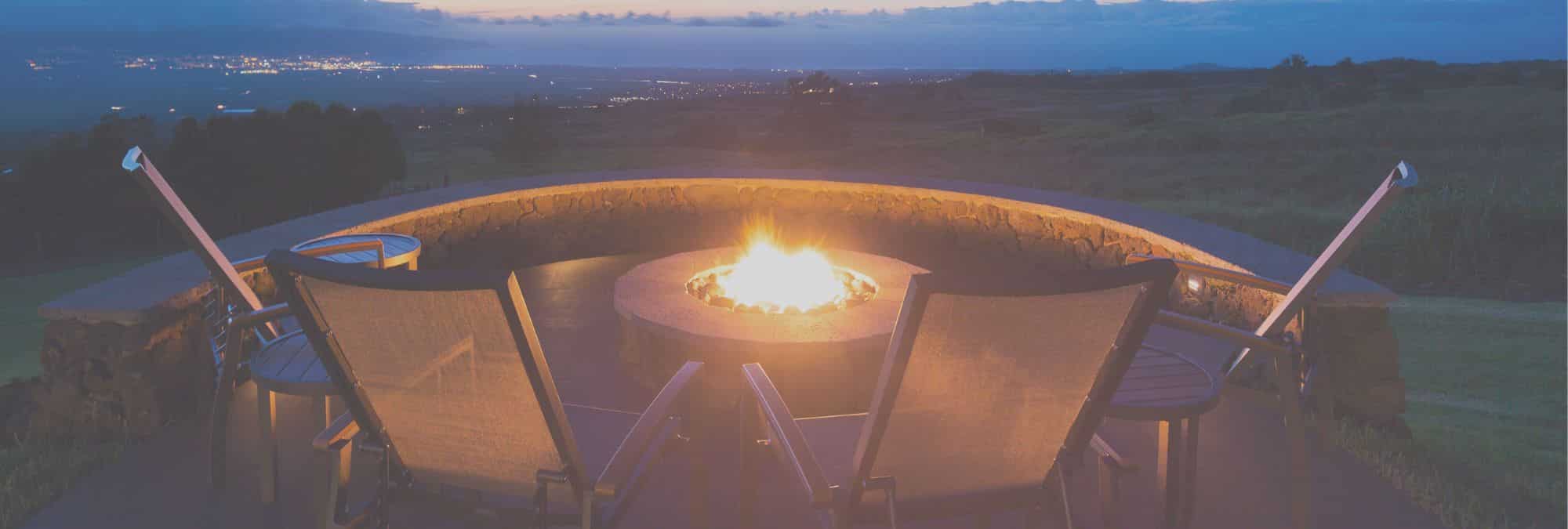 buying second home with backyard fire pit fire burning sunset rain cloud horizon with city lights in valley