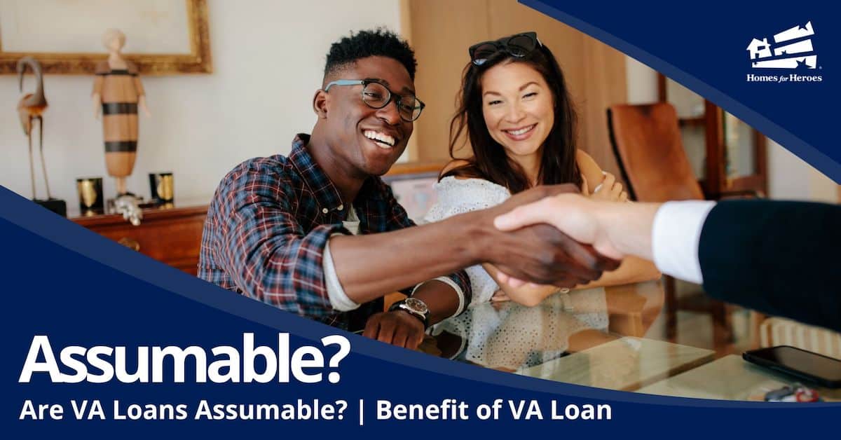 happy couple sitting at glass table man shaking hand in suit after learning va loans assumable Homes for Heroes