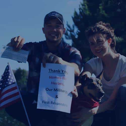 EMS first responder couple with dog American flag holding thank you sign and Homes for Heroes Hero Rewards Savings check