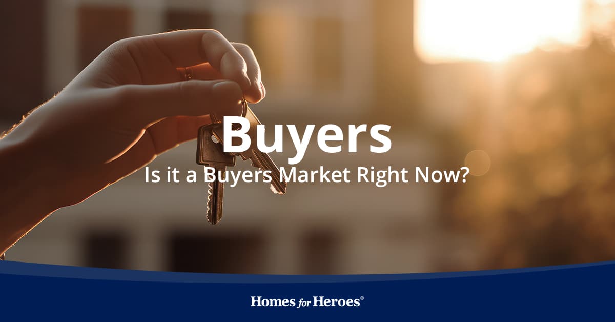 Hand holding house keys representing the current buyers market in real estate