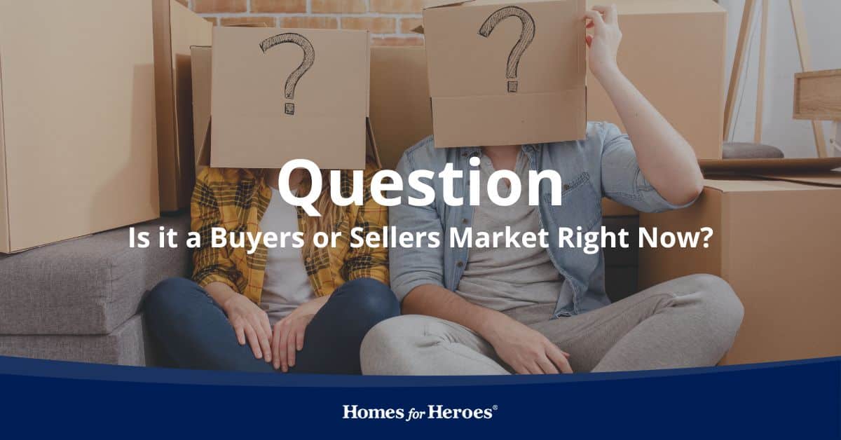 couple on floor surrounded by packed boxes with boxes on their heads with question mark trying to determine if it is buyers or sellers market Homes for Heroes