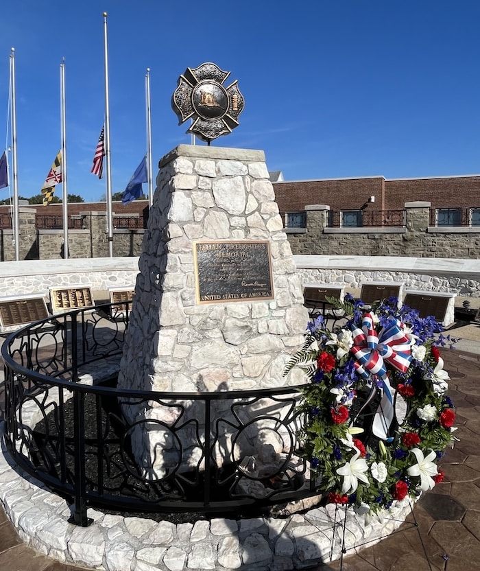 fallen firefighter memorial with wreath flags at half mast to honor fallen